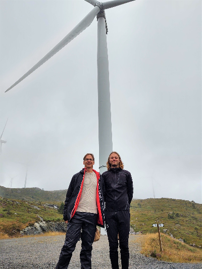 Two NTRANS PhDs in front of windmill