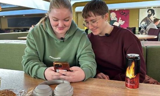 Foto av to jenter som ser på en mobiltelefon