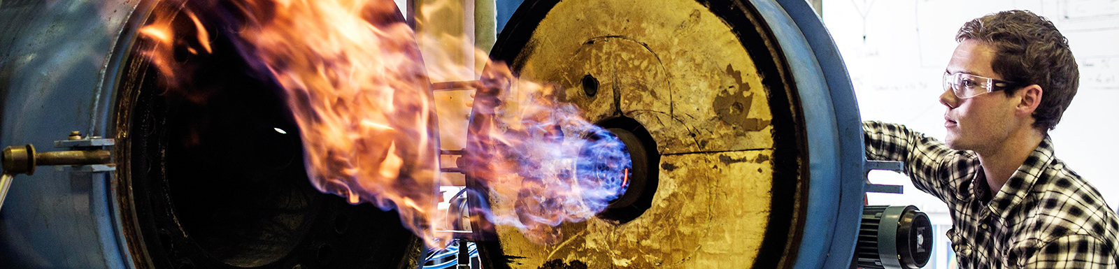 Photo of a man exploring a gas burner.